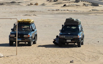 Two SUVs parked in the Black and White Desert during a private safari from Cairo.