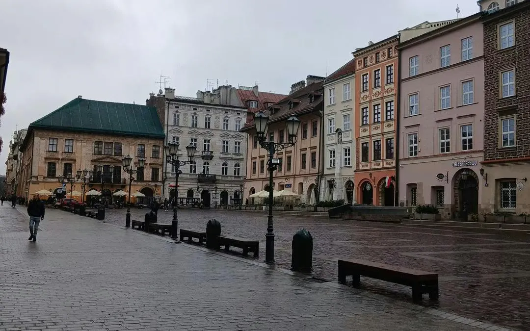 Krakow's historic square with colorful buildings, part of the Murder Mystery city exploration game.