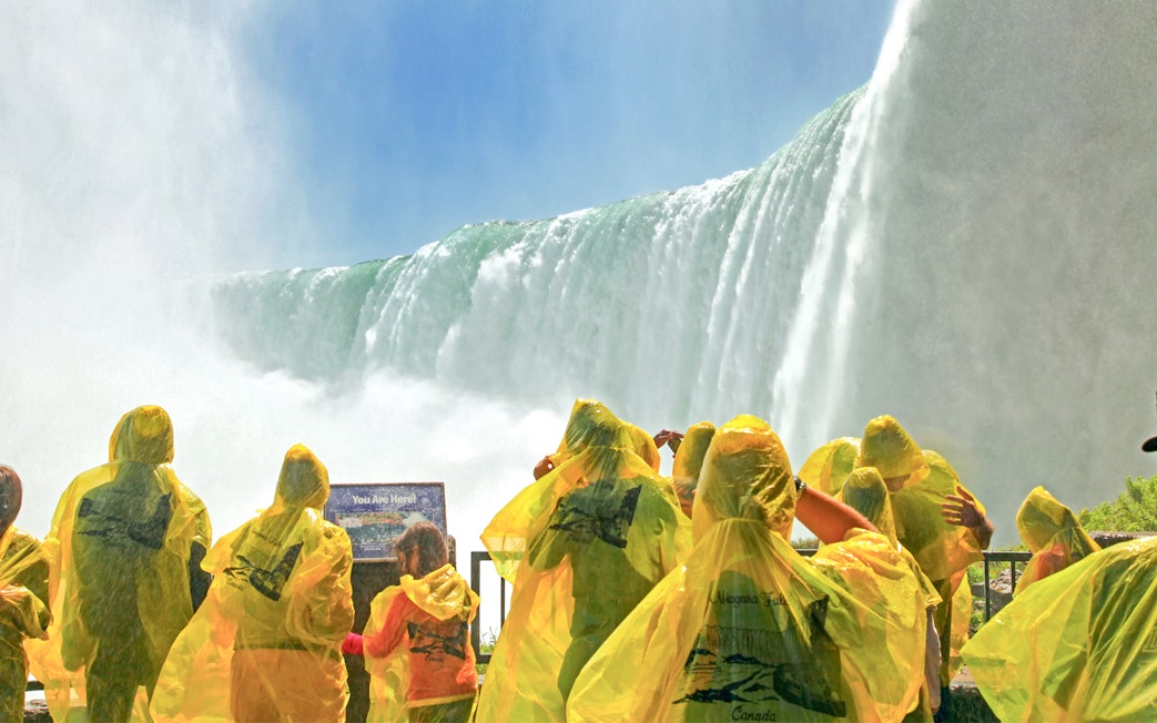 Visitors in yellow ponchos at Journey Behind the Falls, Niagara Falls, Canada.