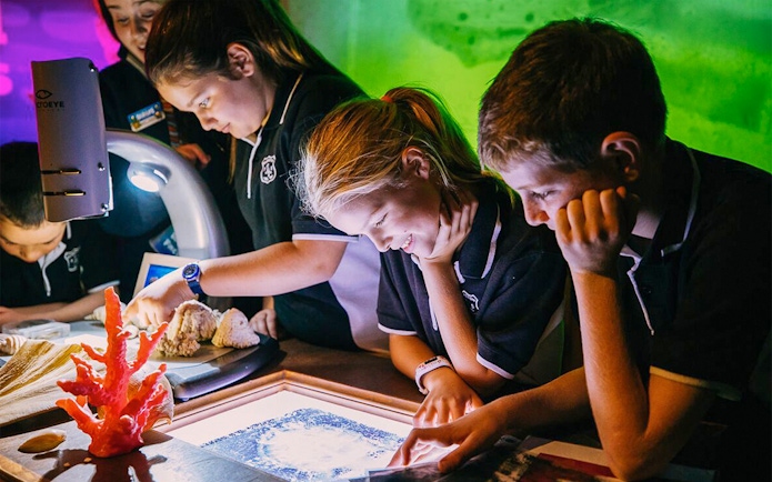 Children exploring interactive exhibits at SEA LIFE Sydney Aquarium.