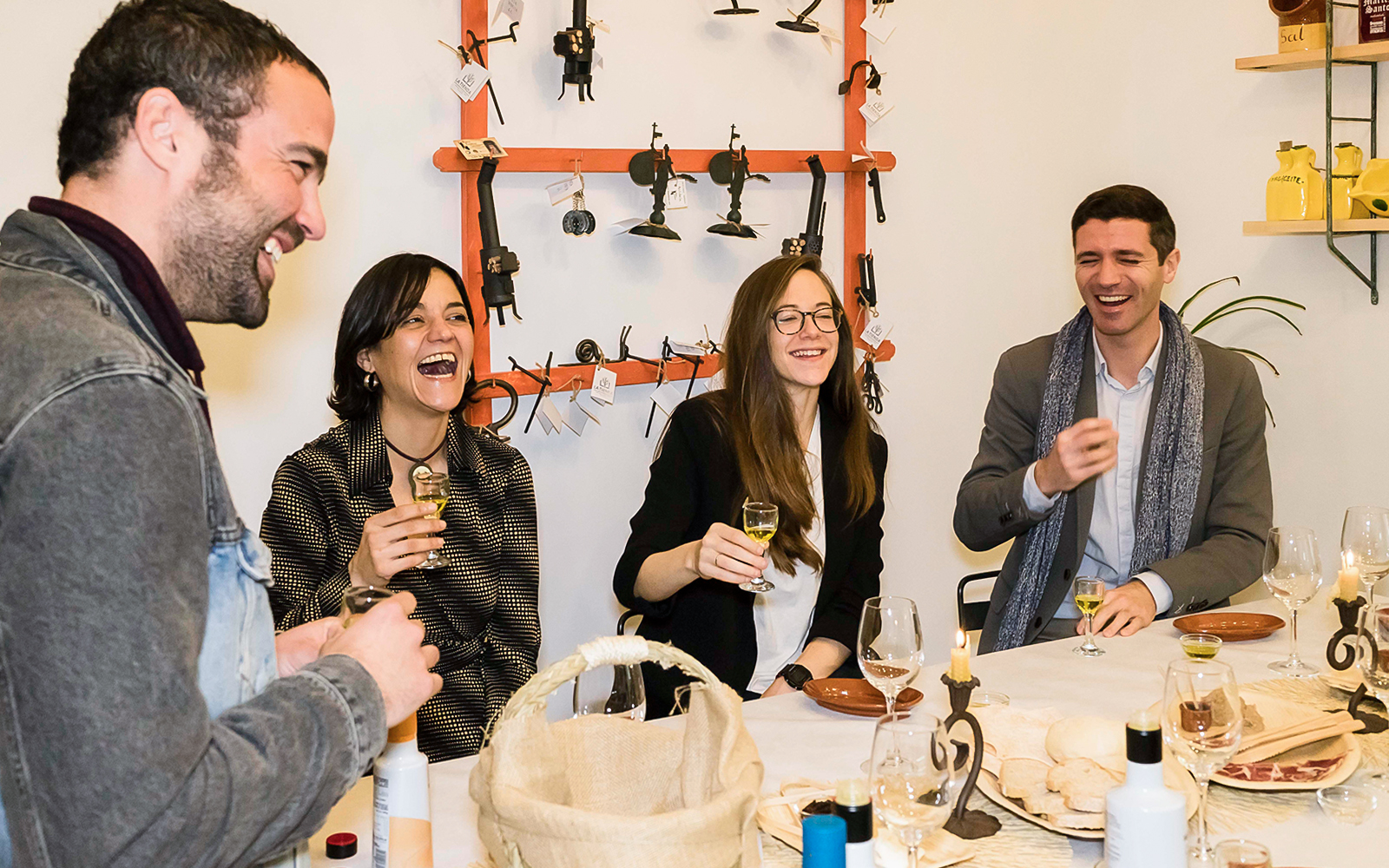 Group enjoying tapas and drinks at a table in Seville during a tasting tour.