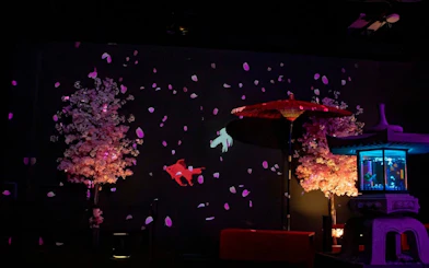 Art Aquarium Museum GINZA with cherry blossoms, koi fish, and lantern display.