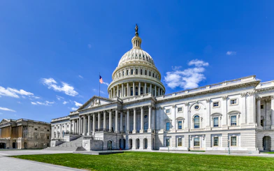 US Capitol Building with dome and American flag, Washington, DC.