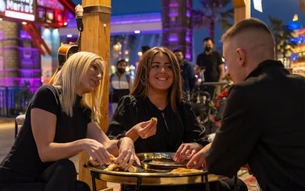 Dining at Global Village Dubai with friends enjoying local cuisine.