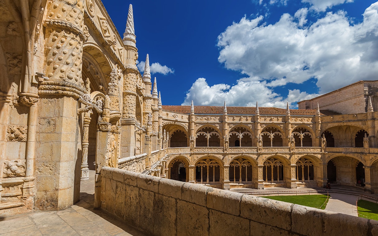 Jeronimos Monastery cloister with ornate arches in Lisbon, Portugal.
