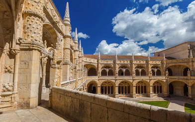 Jeronimos Monastery cloister with ornate arches in Lisbon, Portugal.