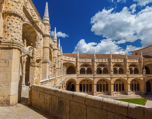 Jeronimos Monastery cloister with ornate arches in Lisbon, Portugal.
