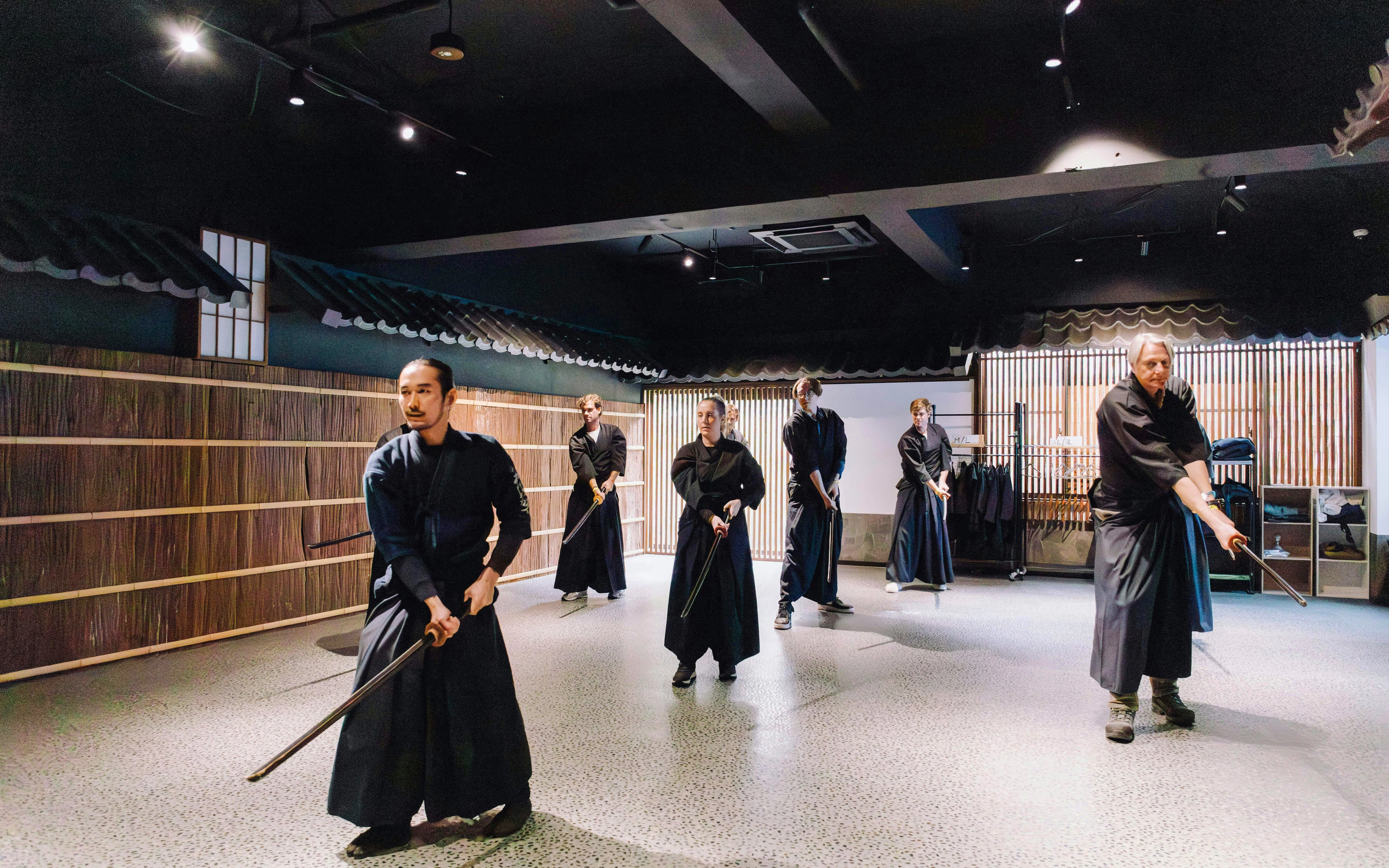 Participants practicing samurai sword techniques in a dojo in Shinjuku.