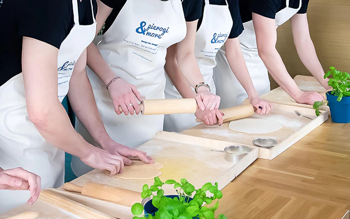 Participants rolling dough in a Polish dumplings cooking class.