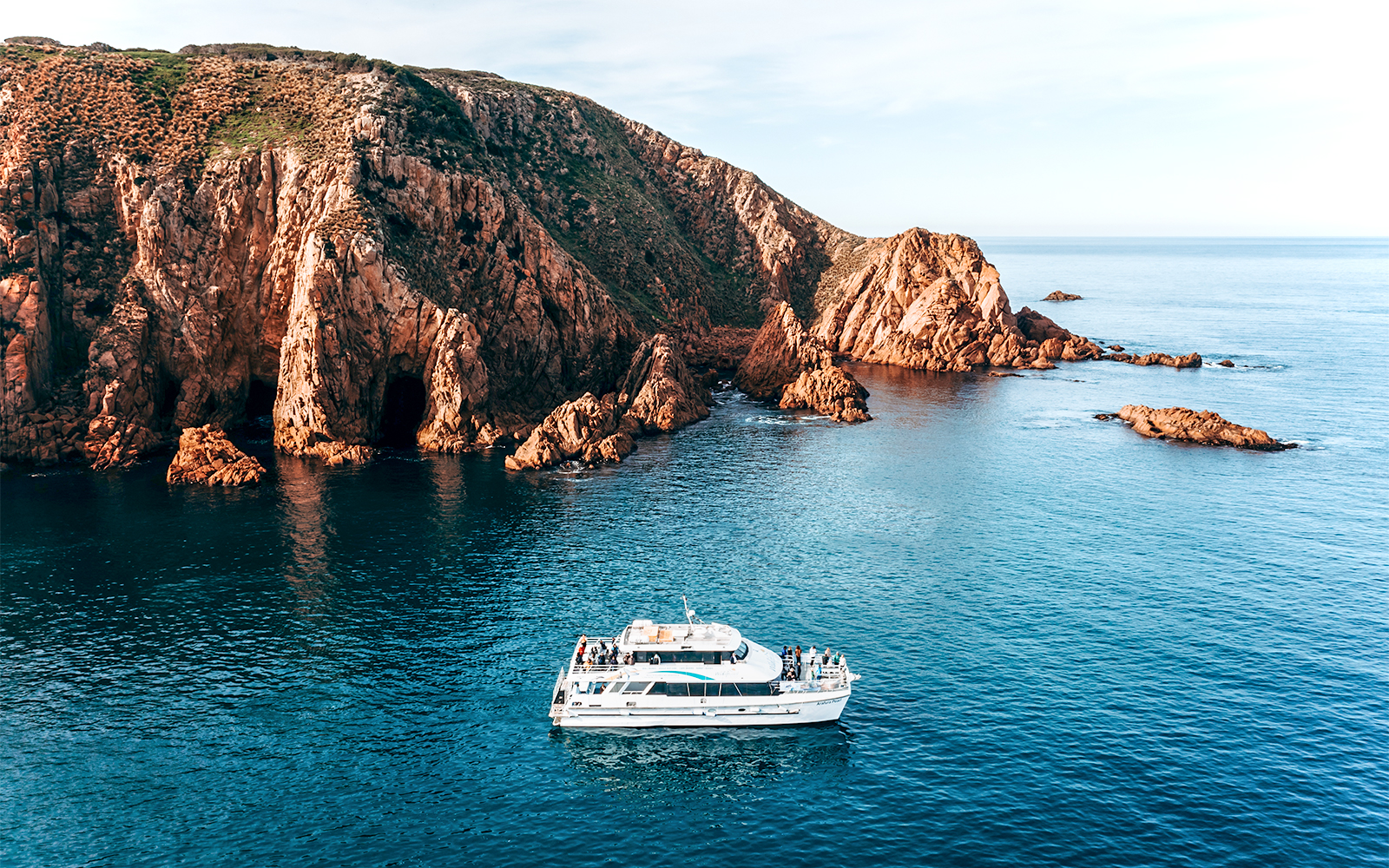 Cruise boat near Cape Woolamai cliffs, Phillip Island, morning view.