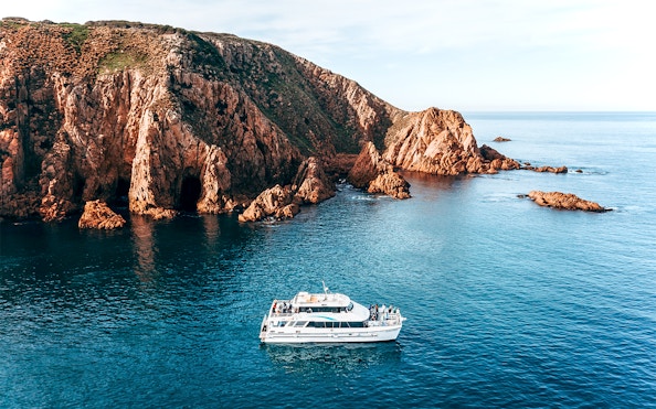 Cruise boat near Cape Woolamai cliffs, Phillip Island, morning view.