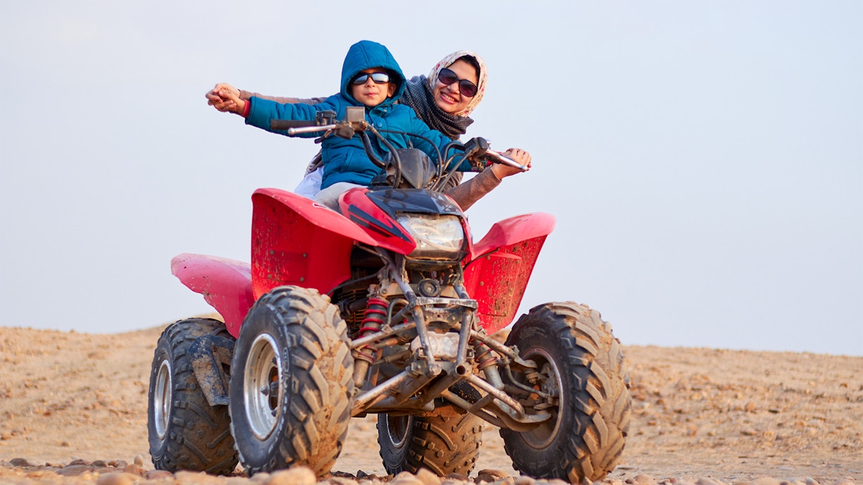 Guests on a quad bike during a guided tour in Agafay Desert.