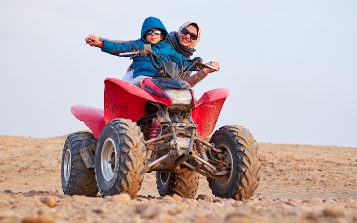 Guests on a quad bike during a guided tour in Agafay Desert.