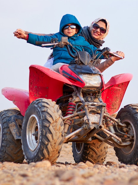 Guests on a quad bike during a guided tour in Agafay Desert.
