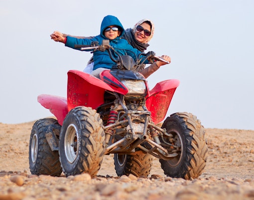 Guests on a quad bike during a guided tour in Agafay Desert.