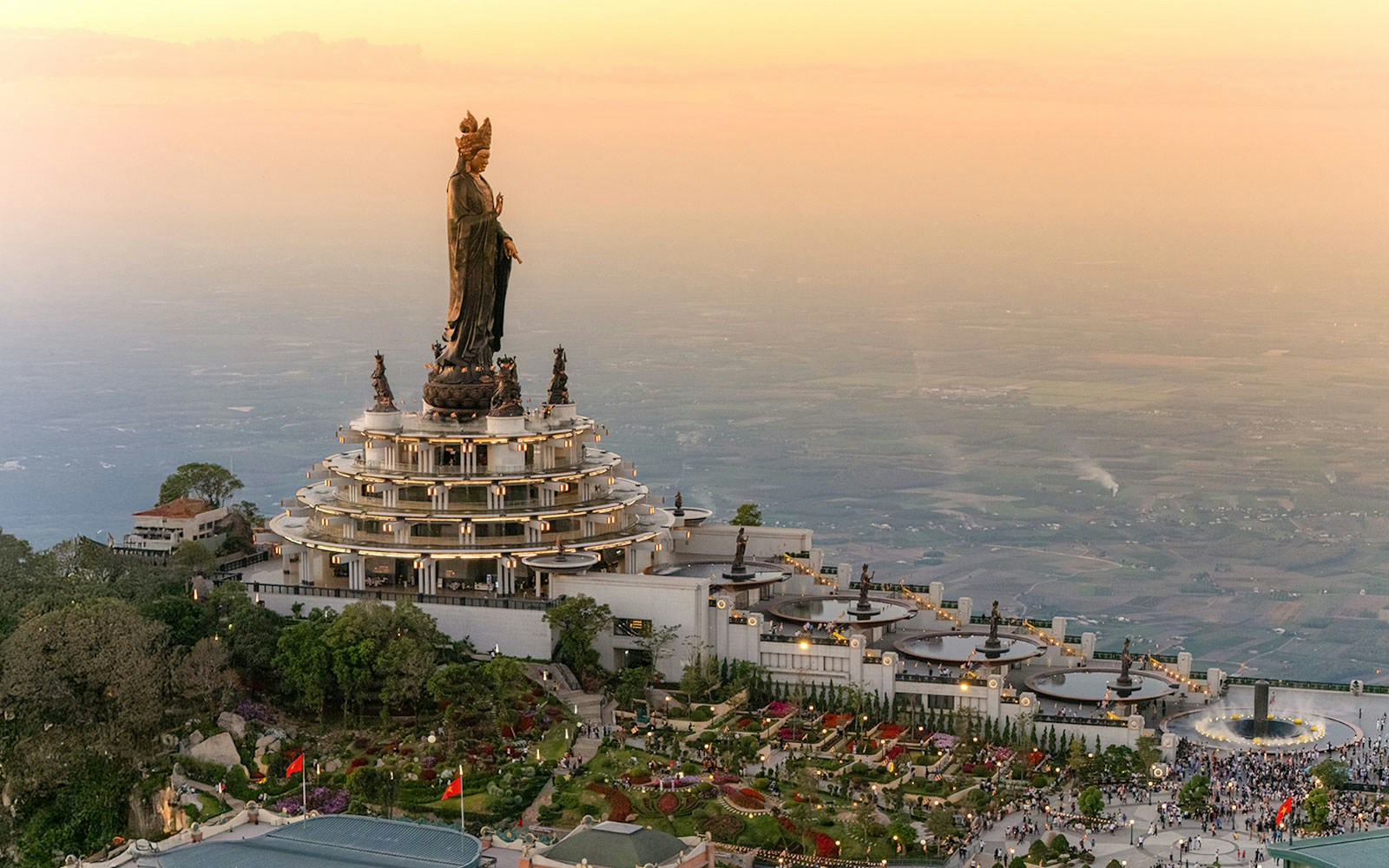Ba Den Mountain temple complex with large statue at sunset, Tay Ninh, Vietnam.