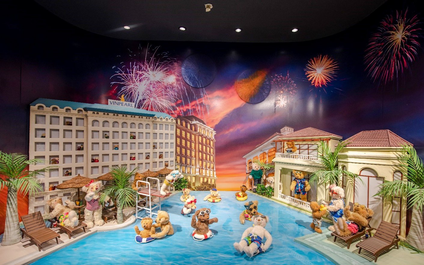 Teddy bears enjoying a pool scene with fireworks at the Teddy Bear Museum.