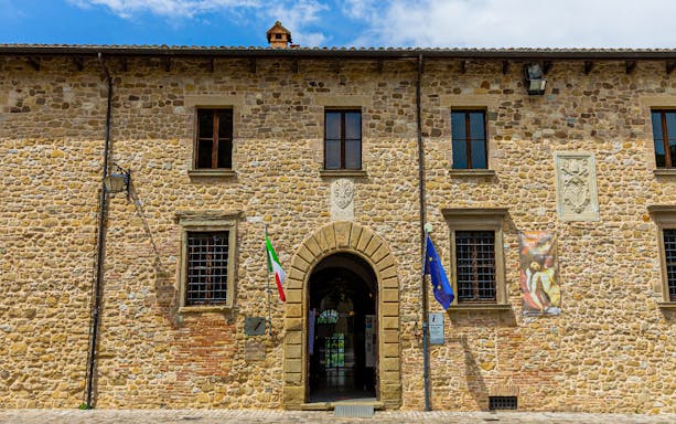 Entrance to San Leo Fortress with Italian and EU flags, Italy.