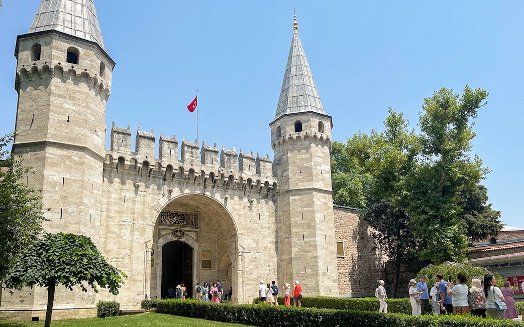 Topkapi Palace entrance with tourists in Istanbul, Turkey.