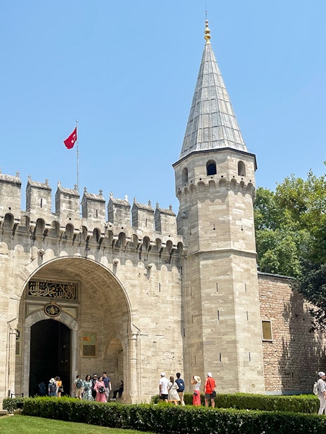 Topkapi Palace entrance with tourists in Istanbul, Turkey.