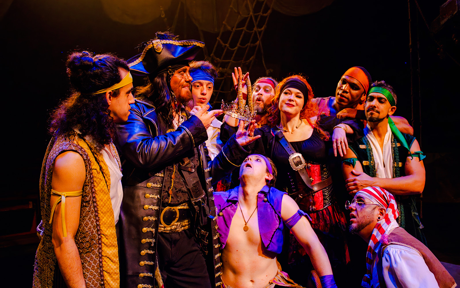 Pirates in costume holding a crown during the Pirates Dinner Adventure Show.