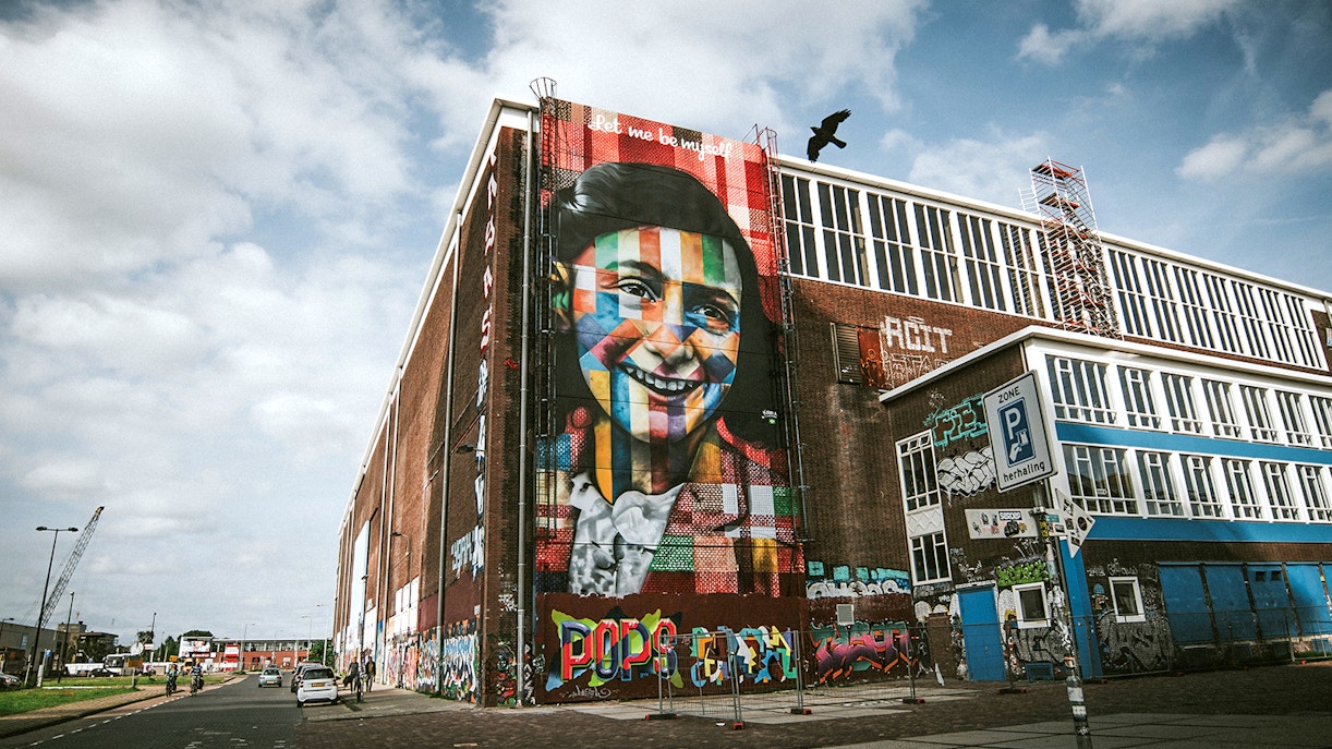 STRAAT Museum mural on a brick building in Amsterdam with street art and graffiti.