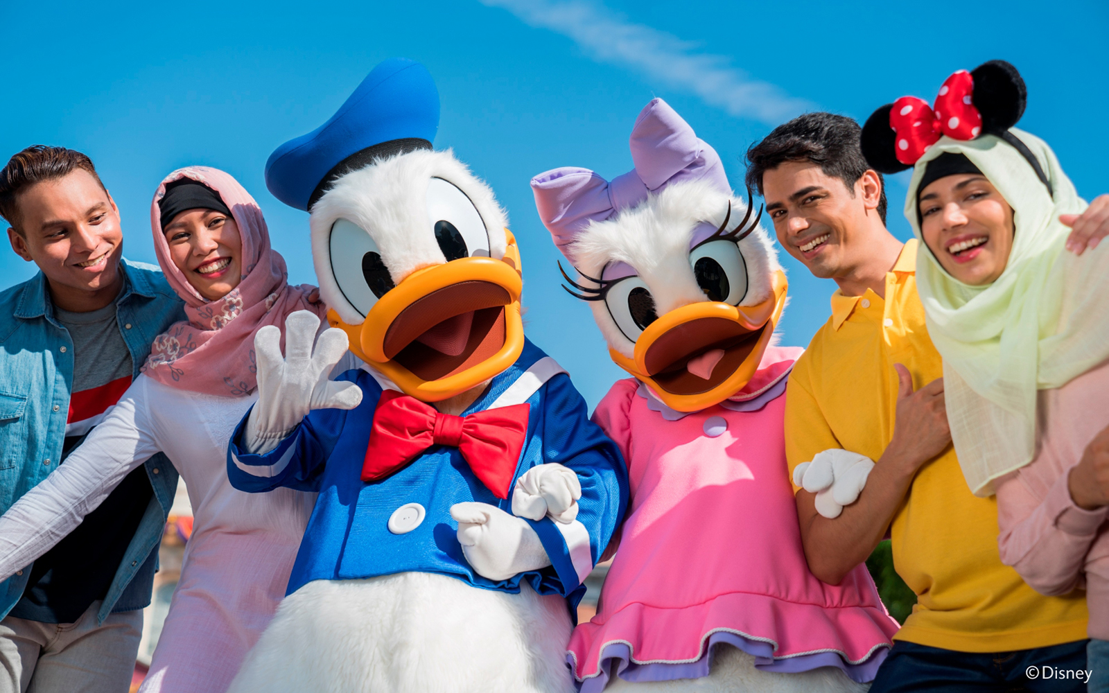 Donald Duck and Daisy Duck with visitors at Disneyland Hong Kong.