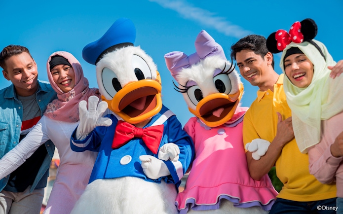 Donald Duck and Daisy Duck with visitors at Disneyland Hong Kong.