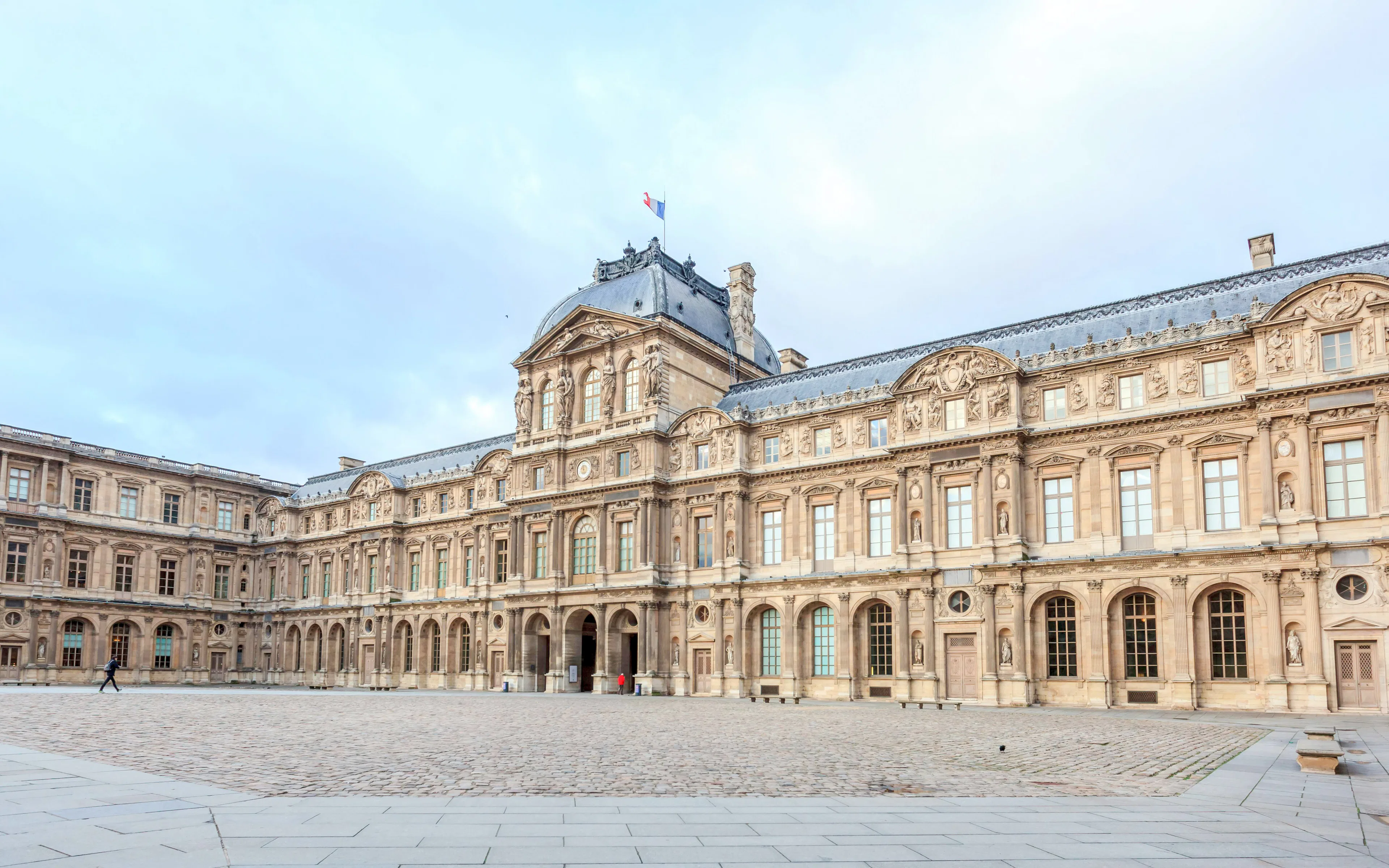 Louvre Museum courtyard with historic architecture in Paris, France.