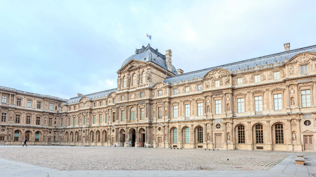 Louvre Museum courtyard with historic architecture in Paris, France.