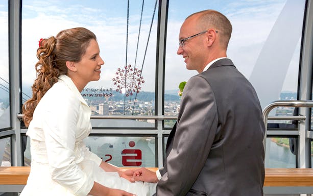 Guests inside Koblenz Cable Car overlooking the Rhine River and Ehrenbreitstein Fortress, Germany.