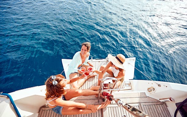 Wine-tasting on a boat in Taormina with friends enjoying the sea.
