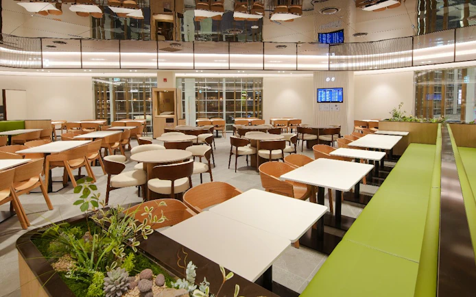 Plaza Premium Lounge interior with seating and greenery, South Korea.