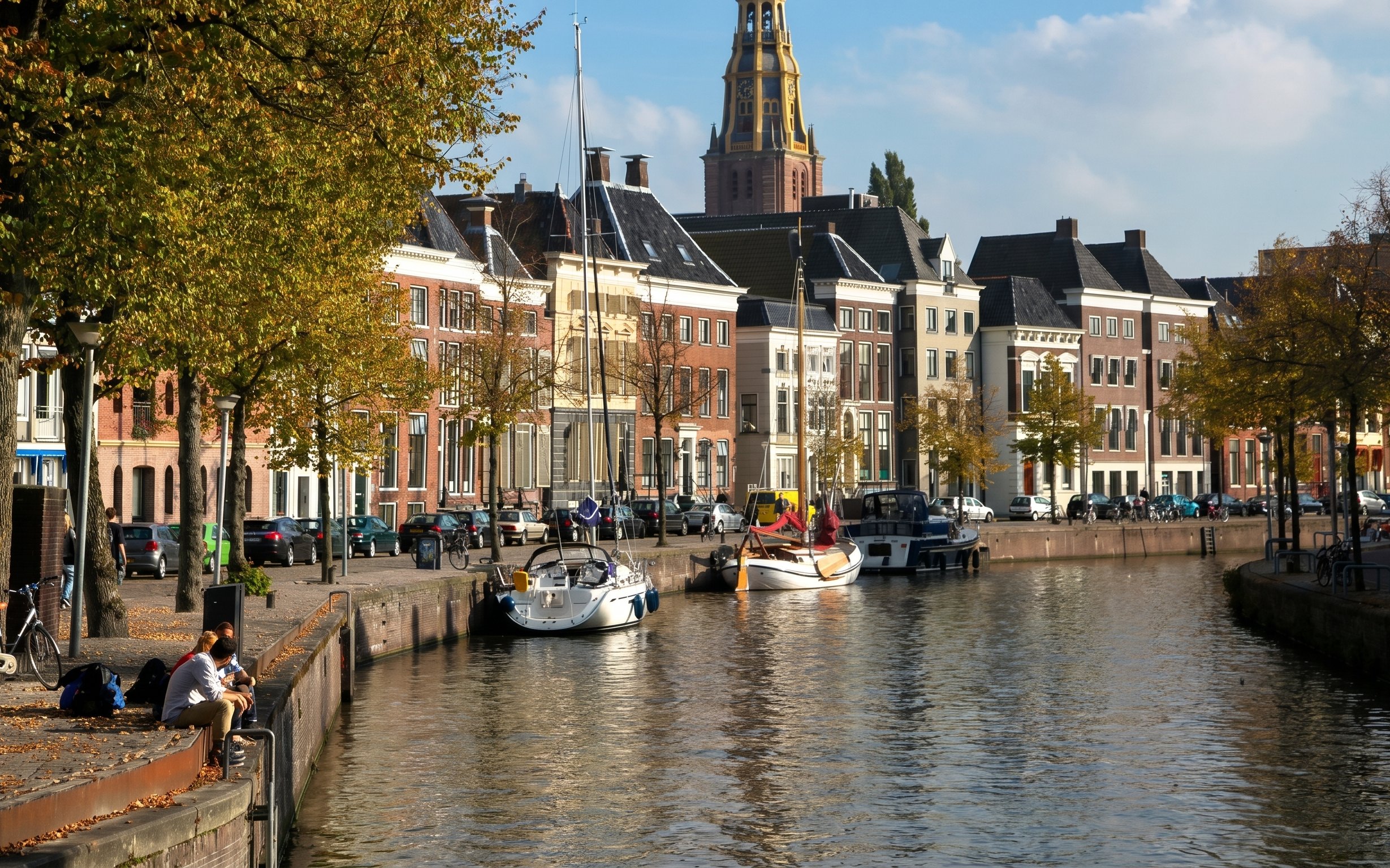 Groningen canal with boats and historic buildings along the waterfront.