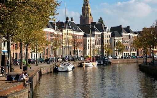 Groningen canal with boats and historic buildings along the waterfront.