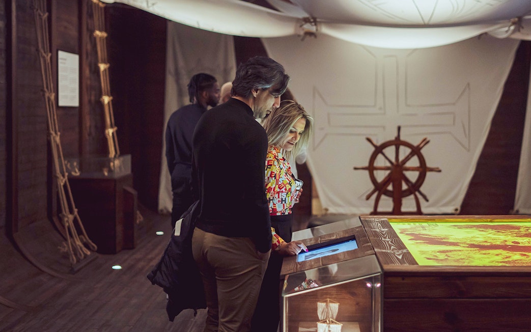 Visitors exploring interactive exhibit at Porto Region Across The Ages Experience.
