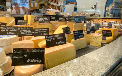 Cheese selection at a market in Engelberg during a guided tour from Lucerne.