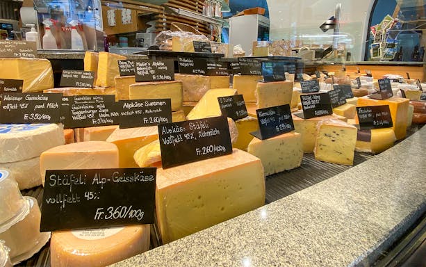 Cheese selection at a market in Engelberg during a guided tour from Lucerne.
