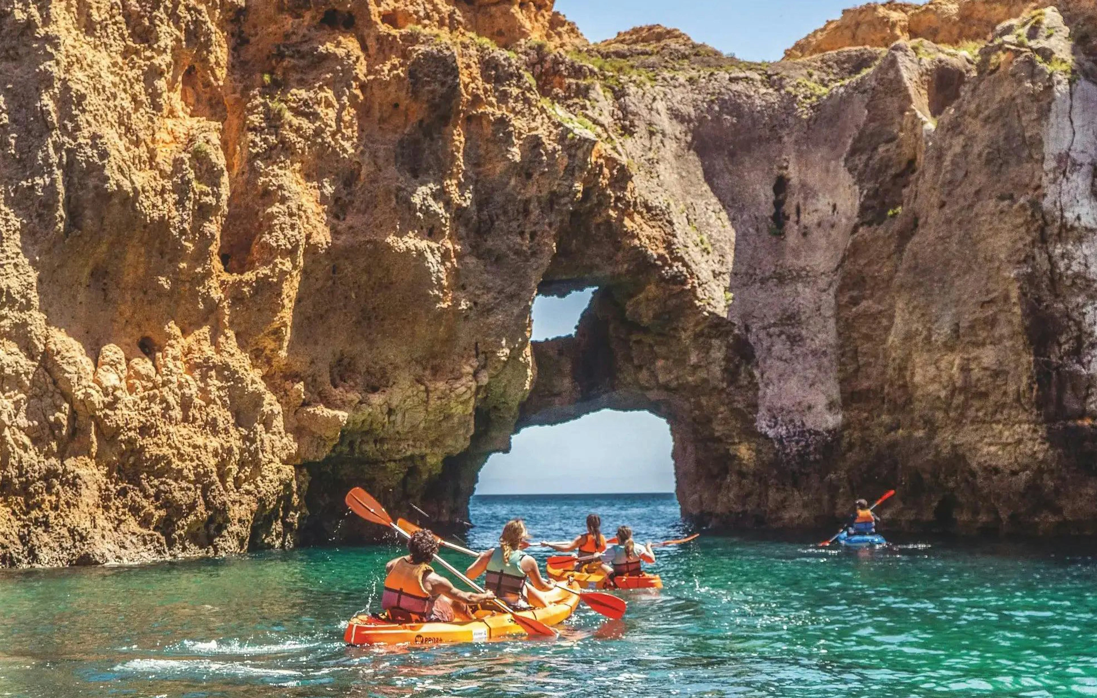 Kayakers exploring sea caves at Ponta da Piedade, Algarve.