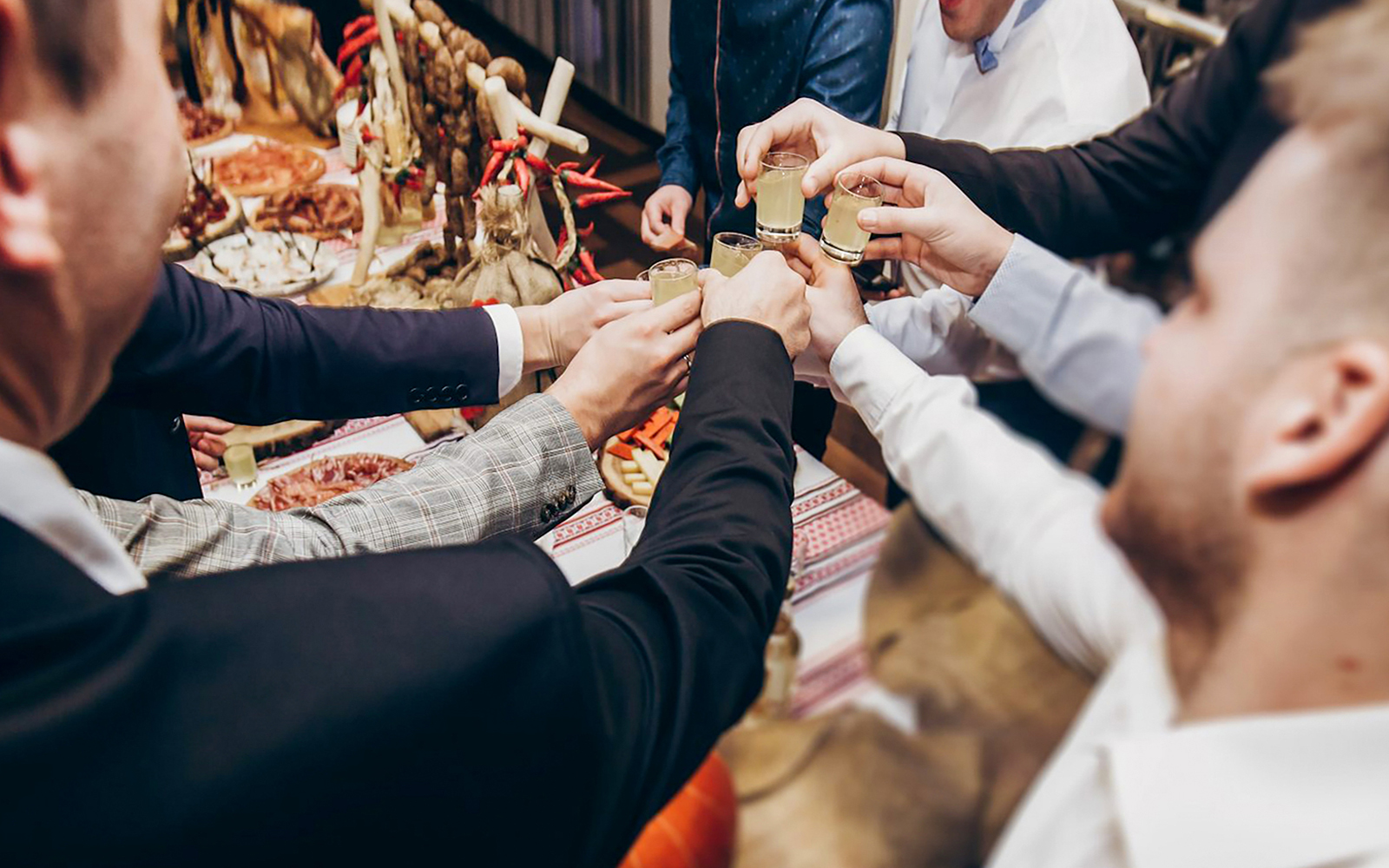 People toasting with vodka shots at a tasting event in Wroclaw.