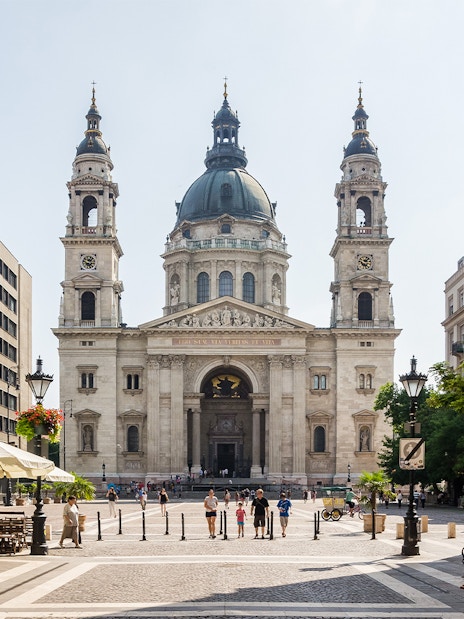 St. Stephen's Basilica facade with surrounding street view in Budapest, Hungary.