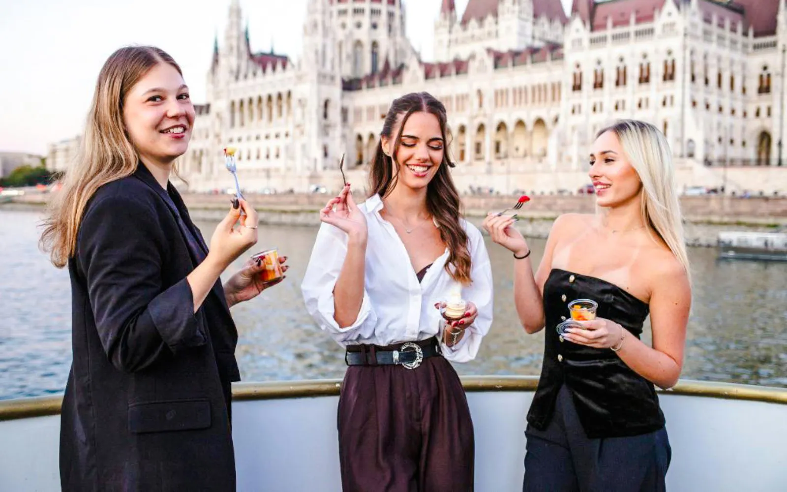 Guests enjoying snacks on Budapest Danube River Dinner Cruise with Parliament view.