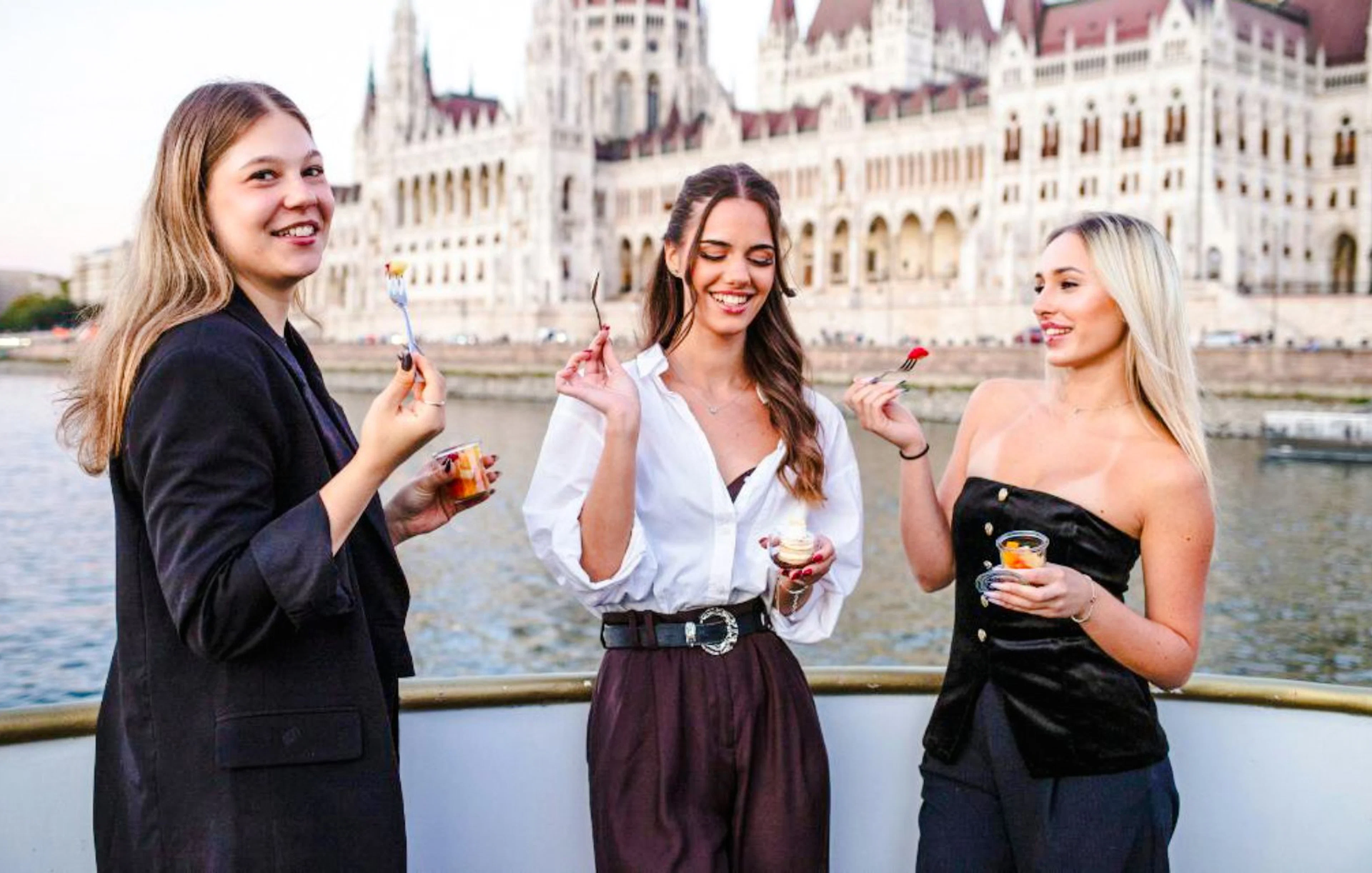 Guests enjoying snacks on Budapest Danube River Dinner Cruise with Parliament view.