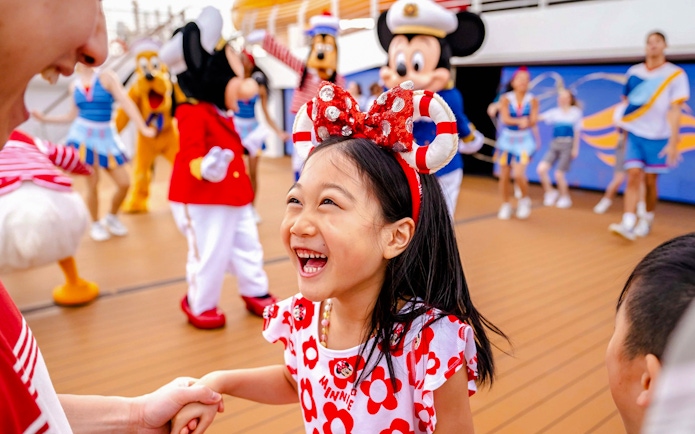 Child enjoying Disney characters on deck during 3-night cruise from Singapore.