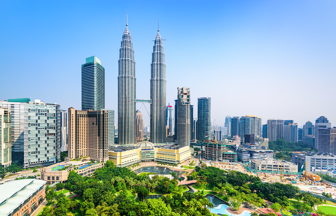 Petronas Twin Towers in Kuala Lumpur with city skyline in the background.