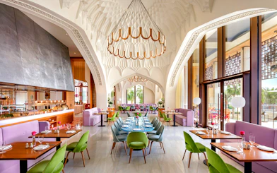 Dining area of Arianas Persian Kitchen with elegant decor and colorful seating.