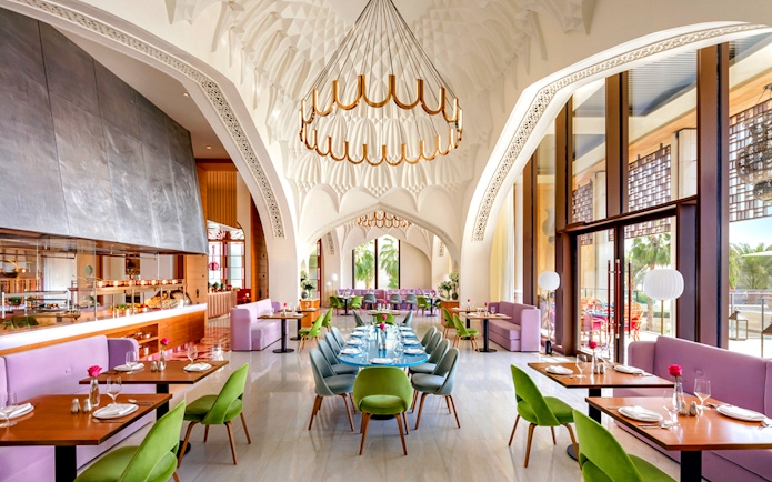 Dining area of Arianas Persian Kitchen with elegant decor and colorful seating.