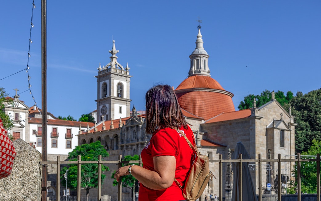 Tourist admiring the Church of Saint Ildefonso in Porto during Douro Historical Tour.