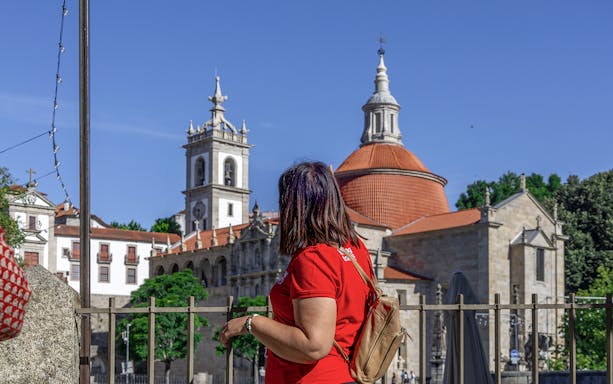Tourist admiring the Church of Saint Ildefonso in Porto during Douro Historical Tour.