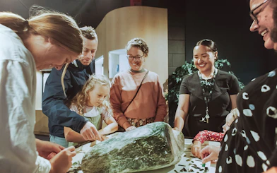 Group examining jade stone during Mountain Jade Highlights Tour.